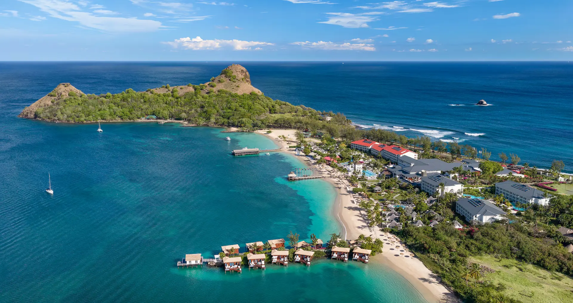 Aerial view of Sandals beach resort with overwater bungalows