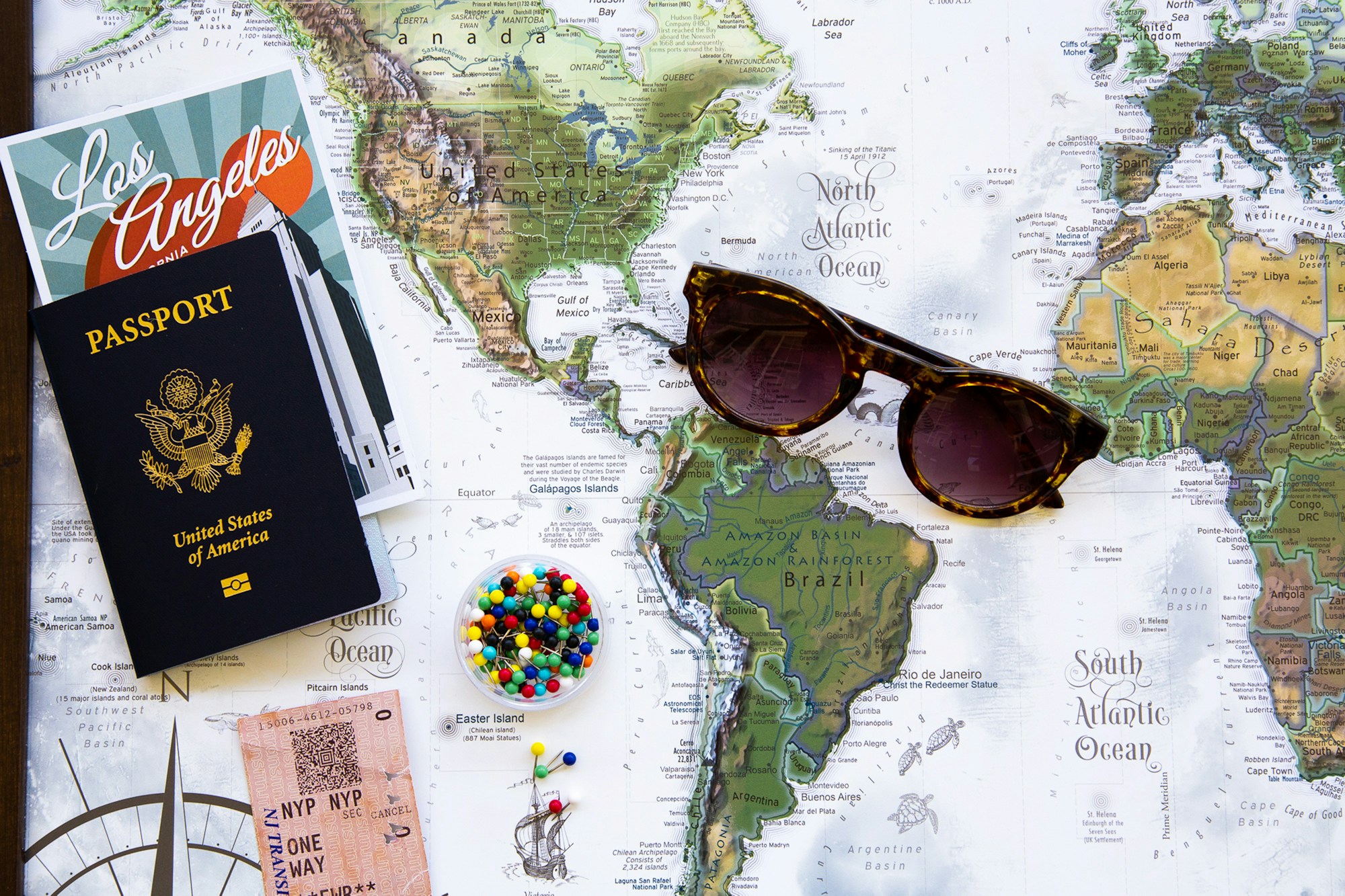 Passport sunglasses world map flatlay