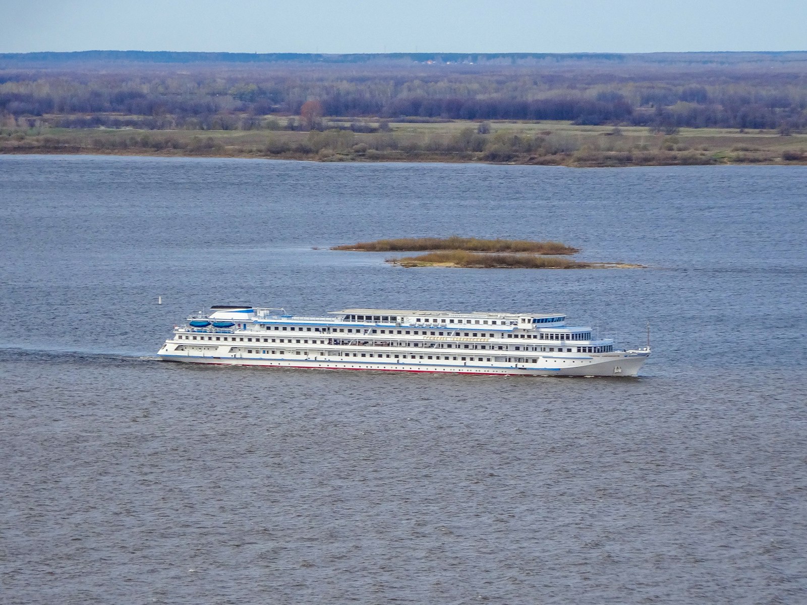 River cruise ship gliding past a riverside European village