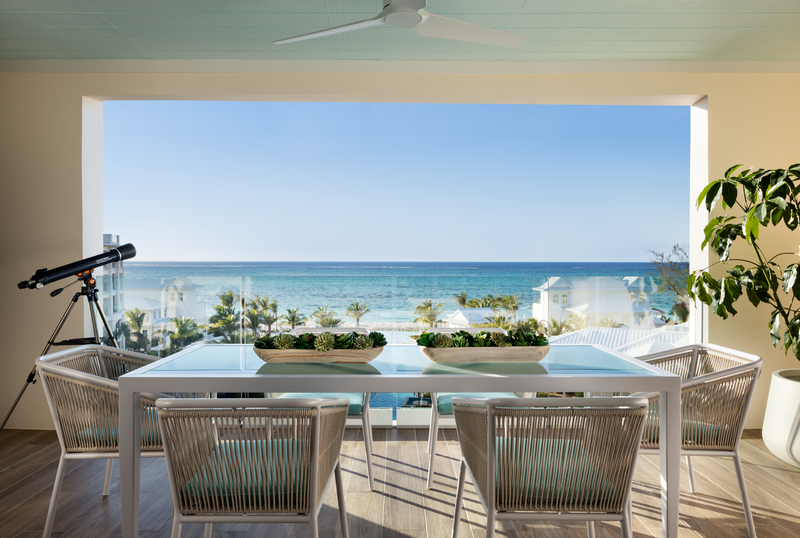Oceanfront balcony dining area with sweeping turquoise water views at Beaches Turks & Caicos
