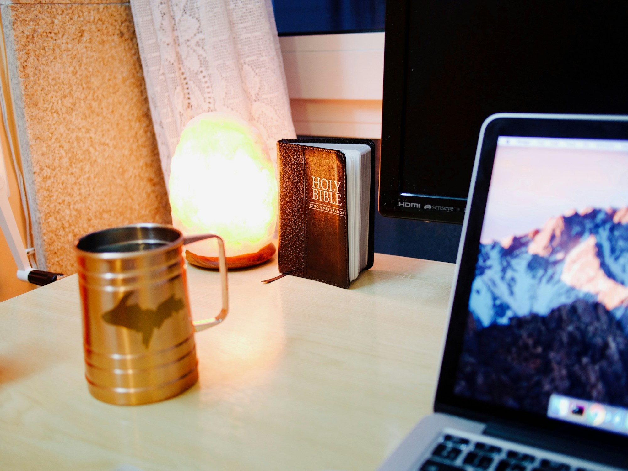 Coffee and notebook on a desk while planning a trip
